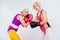 side view of senior sportswomen in boxing gloves training and looking at camera
