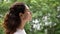Side view serene young woman standing outdoor breathing fresh air