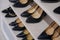 Side view of shelves of a shoe store with women`s shoes on sale. Rows of new shoes in a store