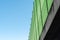 Side view shot of a green noise barrier on a concrete bridge under blue sky in Wetzlar, Germany