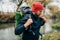 Side view shot of young hiker male hiking in mountains with travel backpack. Traveler bearded man relaxing after mountaineering