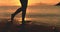 Side view silhouette woman legs walk sunset beach