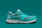 Side view of single turquoise running shoe
