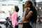 Side view of slim black african-american fitness instructor and asian lovely woman doing fitness exercise work with