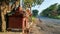 Side view of small hindu temple of goddess bhavani or tulaja bhavani mata, small wooden swing cradle , copper bell hanging around