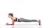 side view of smiling sportswoman doing plank exercise on yoga mat