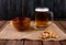 side view snacks for beer hard chuck in bowl and crackers with mug of beer on wooden background