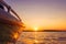 Side view Speeding fishing motor boat with drops of water. Blue ocean sea water wave reflections at the sunset. Motor boat in the