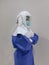 Side view of standing Asian woman doctor wear full Personal Protective Equipment PPE and PAPR Powered Air Purifying respirator