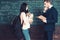 Side view student and professor having a discussion. Girl with heavy backpack and pile of books in her hands standing