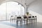 Side view on stylish dining table surrounded by wooden chairs on light floor in sunny room with brick wall and skyscrapers view