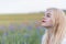 Side view of sunbathing beautiful young woman posing in summer field