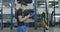 Side view of tired brunette service man rubbing face and hands with cloth in repair shop. Portrait of exhausted