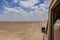 Side view of a tourist vehicle driving in the desert at Chalbi Desert, Marsabit, Kenya