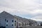 Side view of townhouses with snowy gable roofs against overcast sky in winter