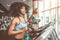 Side view of two attractive sports women on running track. Girls on treadmill