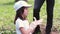 Side view video of a nice girl in white cap and t-shirt straightens gloves and yawns while doing volunteer work for
