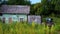 Side view of village farm wooden house and wooden fence, view