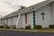 Side view of a vintage green and white stucco Church