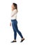 Side view of walking casual beauty in jeans talking on the phone looking away