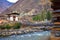 side view of walking suspension bridge with a lot of colorful prayer flags in Bhutan