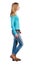 Side view of walking woman in jeans.