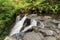 Side view of a waterfall cascading over a rock ledge, New Zealand