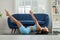Side view of Wellness Asian woman wear blue sportswear doing Yoga exercise,Yoga Fish pose Matsyasana,Calm of healthy young woman