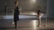Side view wide shot of slim woman and inspired girl rehearsing eleve at barre in ballet studio. Confident Caucasian