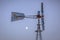 Side view of a windpump with moon and sky in the background