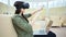 Side view woman enjoying modern vr technology using 3D virtual reality headset and laptop