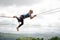 Side view woman lying on the slackline rope and looking into the distance