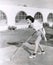 Side view of woman playing shuffleboard