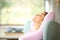 Side view of a woman resting and relaxing on a couch at home