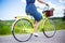 Side view of woman riding retro bicycle in countryside