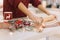 Side view of womans hands rolling cookie dough