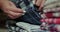 Side view: Women's hands sort through a stack of men's shirts