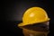 Side view of a yellow construction safety helmet