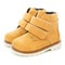 Side view of yellow leather children's boots for little girls on a white background.