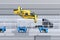 Side view of yellow Passenger Drone Taxi, fleet of delivery drones flying along with truck driving on the highway