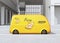 Side view of yellow self-driving pizza delivery van parking side of the road