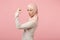 Side view of young arabian muslim woman in hijab light clothes posing isolated on pink wall background. People religious