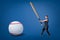 Side view of young athletic man in gym suit, holding enormous bat and ready to hit huge baseball.