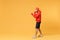 Side view of young bearded fitness sporty guy boxer sportsman in hat, hoodie, shorts in home gym isolated on yellow