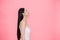 Side view of Young beautiful and calm Asian woman isolated over pink background.