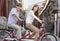 Side View of Young Heterosexual Couple on a Tandem Bicycle in Beijing Looking at Camera