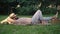 Side view of young male farmer sleeping lying on green meadow with harvest. Wide shot of tired Caucasian man taking a