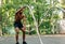 Side view of young man exercising with battling ropes