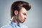 Side view of young man with retro classic pompadour hairstyle.