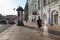 Side view of young man in shorts walking at sidewalk on Nevsky Prospekt